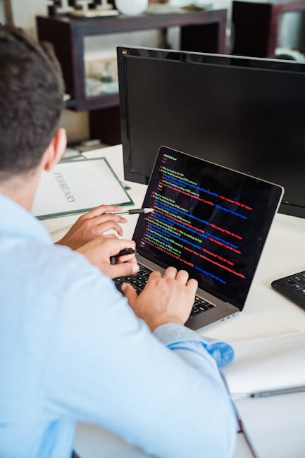 A close-up view of a computer screen displaying HTML code in a dark mode editor. The code includes tags such as <!DOCTYPE html>, <html>, <head>, <title>, and <link>, with syntax highlighting in blue, 